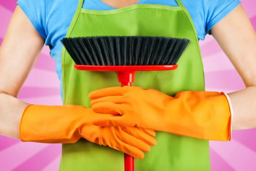 Professional cleaner disinfecting high-touch surfaces in shared space